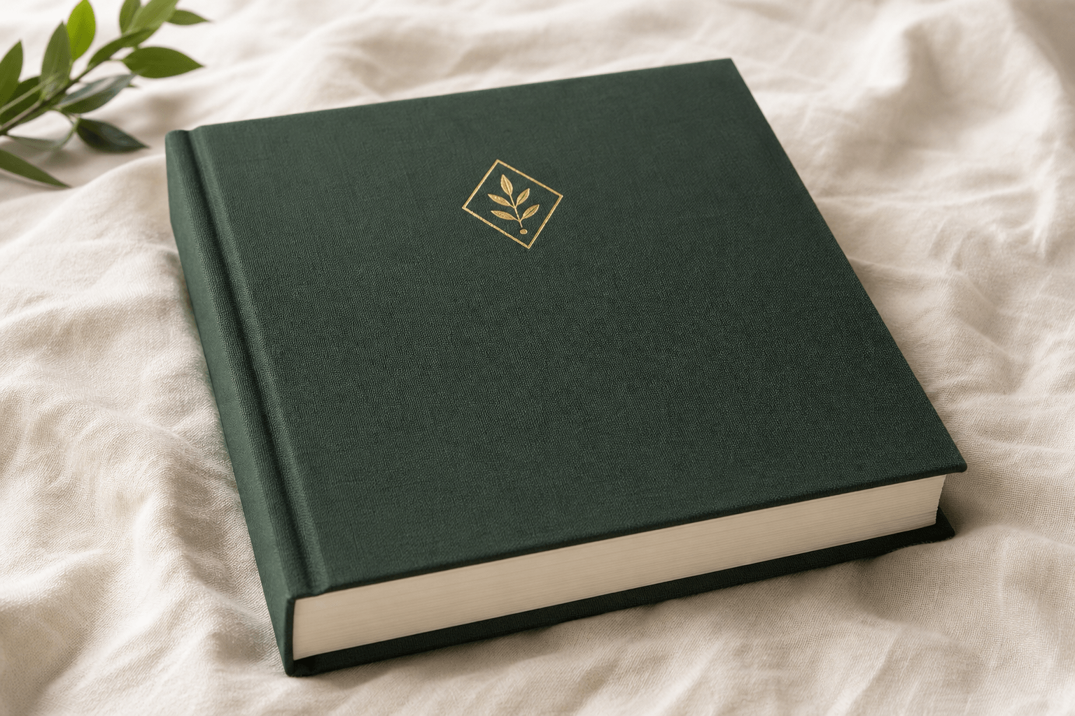 Dark forest-green hardcover memory book with gold foil DeeperRoots mark